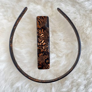 overhead view of a vintage French tortoise patterned headband and barrette