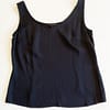 Front view of an Escada silk camisole in black, showing a slight v-neck neckline.