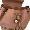 Front view of a Banana Republic leather backpack showing the drawstring closure and front zippered pockets