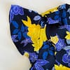 Sleeve detail of preloved Banana Republic floral wrap blouse in a blue, yellow and pink print