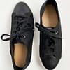 Top view of a pair of pre-loved Banana Republic black flyknit low-top sneakers for women, showing the black uppers, white sole, leather insole and black tie laces.
