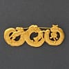 Signed vintage JJ Jonette gold-tone brooch featuring four playful cats climbing on interconnected circular rings.