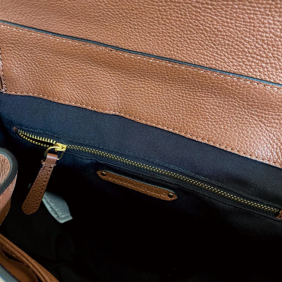 closeup of the inside of a baclpack showing the internal zippered pocket