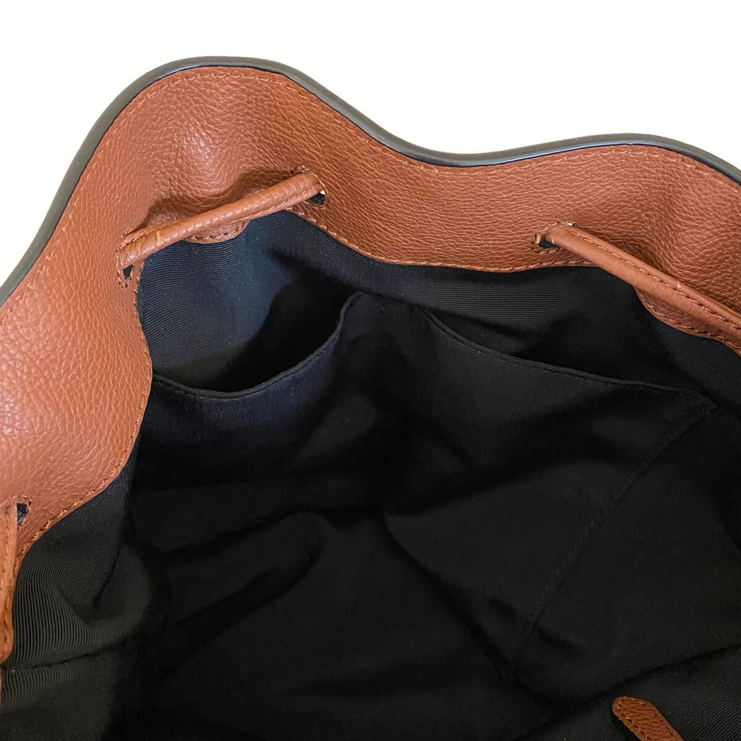 closeup view of the inside of a preloved Banana Republic brown leather backpack showing the internal pockets