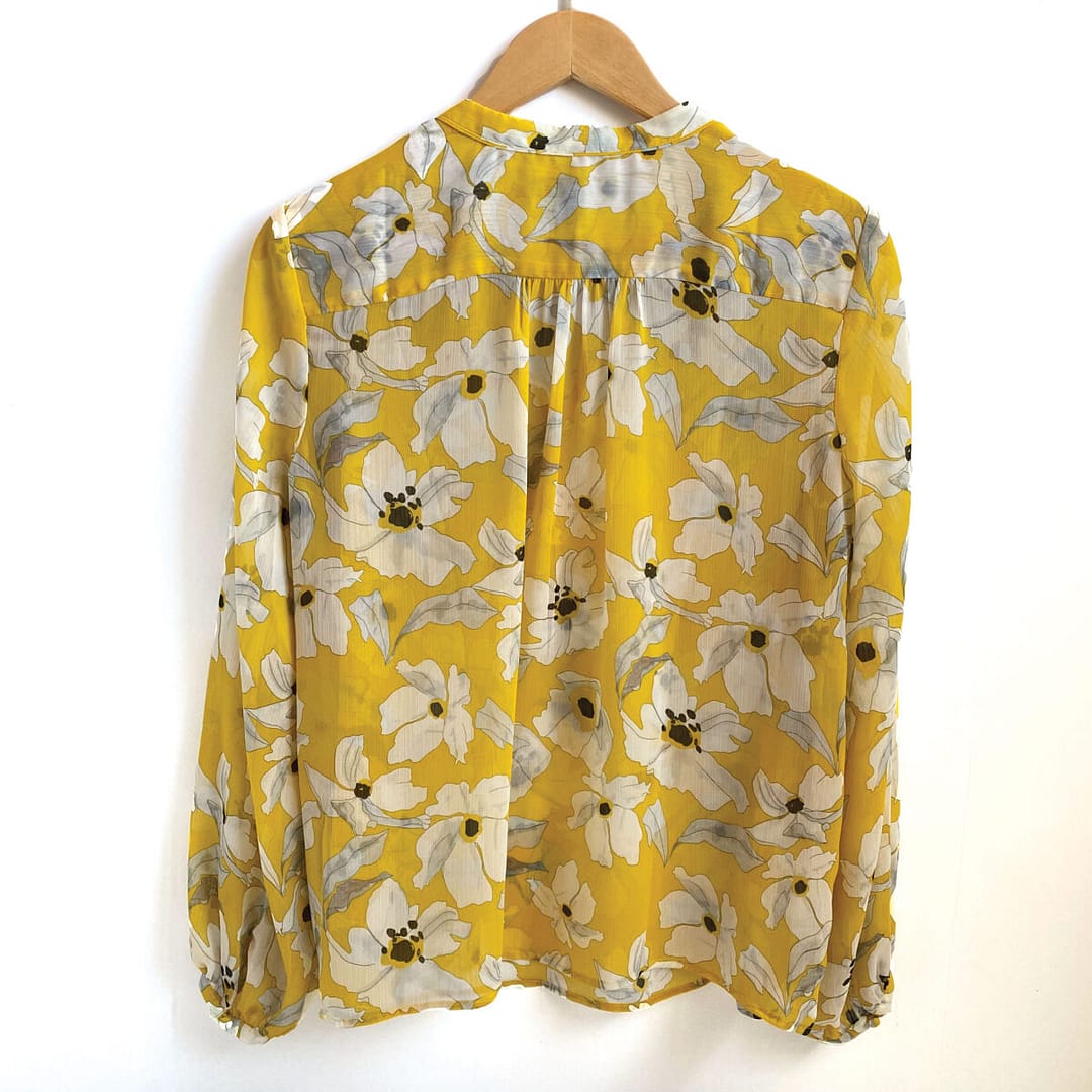 Rear view of a Banana Republic floral blouse in yellow