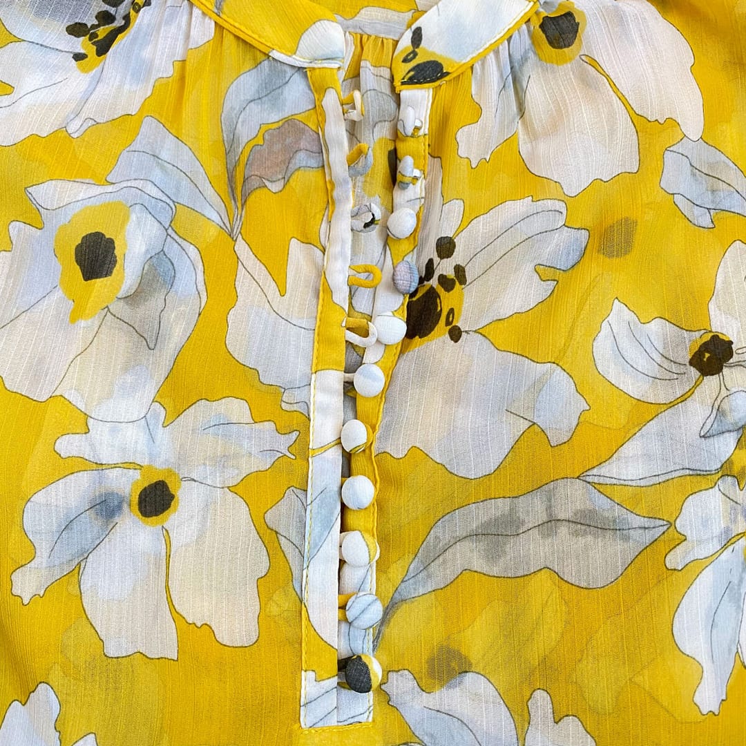 Closeup of Banana Republic floral blouse with detail of looop-and-button placket